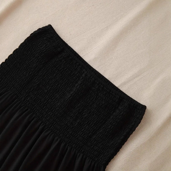 The solid-colored top is off-the-shoulder and strapless