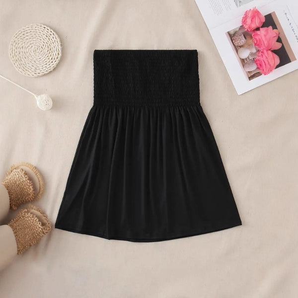 The solid-colored top is off-the-shoulder and strapless